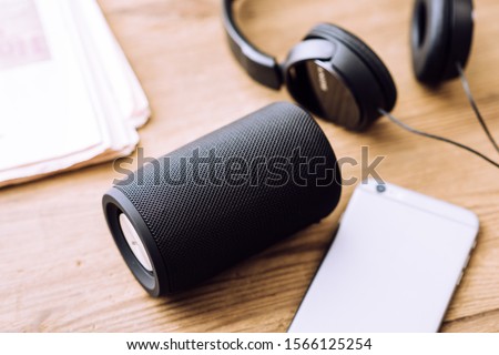 Black mini wireless portable bluetooth speaker for music listening. 