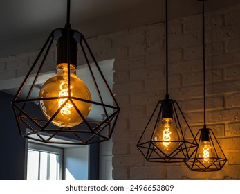 black minimalist loft chandelier with LED filament lamps in a Scandinavian interior - Powered by Shutterstock