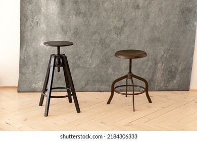 Black Minimalist Metal Chairs Against Grey Background. Concept Modern Interior And Design Furniture In Room. High Stool In Loft Style. Retro Bar Chair. Vintage Wooden Metal Chair. Tall Standing Table