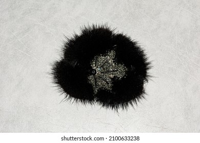 Black Mink Fur Brooch On A Light Background