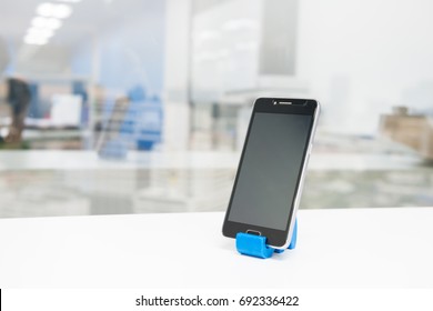 Black Mobile Phone On Phone Holder