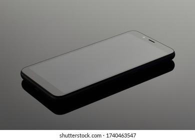 Black mobile smartphone on the surface with reflection