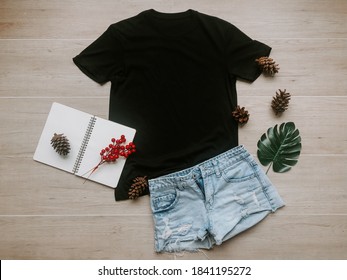 Black Mock Up T Shirt Flat Lay On Wood Background With Book , Jeans, Leaves , Wool Scarf For Winter Season