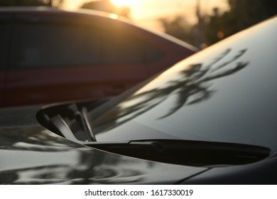 Black Modern Car Road Trip Travel In The Morning With Palm Tree Reflection In Windshield