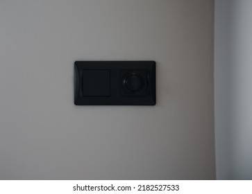 Black Modern Light Switch And Light Dimmer On Gray Wall