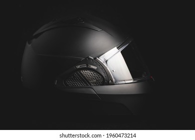 Black modular motorcycle helmet on black background.