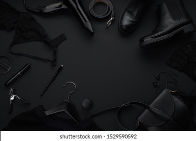 Black monochromatic flatlay on black background. Clothes, accessories and beauty equipment. Black friday sale concept - Shutterstock ID 1529590592