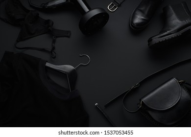Black monochromatic flatlay on black background. Clothes, accessories and beauty equipment. Black friday sale concept - Shutterstock ID 1537053455