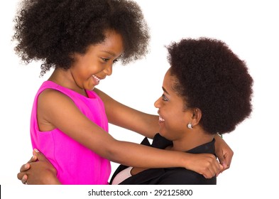 Black mother daughter posing happily and facing each other with big smiles