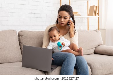 Black Mother Multitasking Caring For Baby, Talking On Phone And Using Laptop Sitting On Sofa At Home. African American Freelancer Mom Working Remotely During Maternity Leave. Motherhood Concept