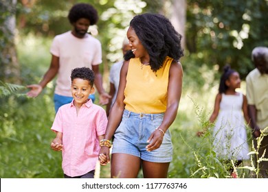 Black Mother And Son Walk With Family And Friends In Woods