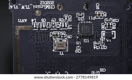 black motherboard with chipsets, memory modules, transistors and contacts