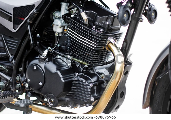 Black motorcycle engine, detail of motorcycle
engine on white
background.