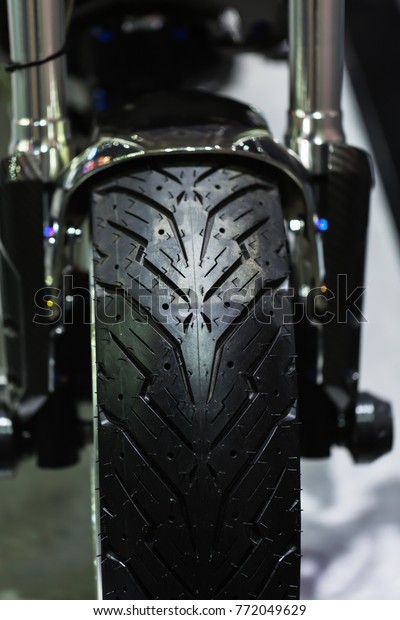 Black\
motorcycle tire.Front wheel of modern\
motorcycle.