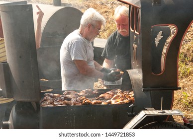 Black Mountain, NC / USA - August 10, 2008:  Older Man Outside Grilling Ribs At A Local Fair In Black Mountain, NC Showing The Extra Large Grill.