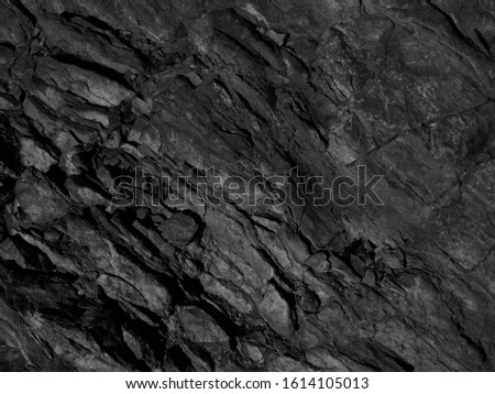   Black mountain texture. Close-up. Dark gray grunge background. Stone background. Black and white background. Monochrome rock texture.                             
