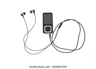 black mp3 player with headphones on white background