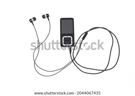 black mp3 player with headphones on white background