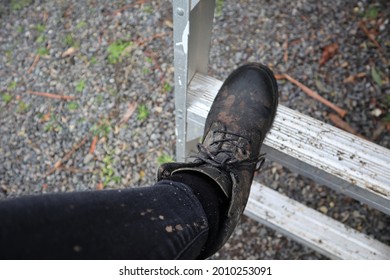 Black Muddy Work Boots Climbing Ladder