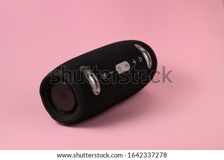 Black Music column on a pink background. Single object. Musical portable speaker.
