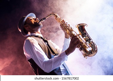 Black musician playing saxophone. Old style jazz.