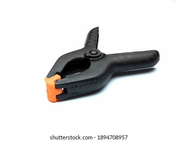 Black Muslin Clamp With Orange Pads For Use In Photo Studio, Isolated On White Background