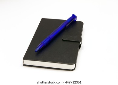 Black notebook with blue ballpoint pen