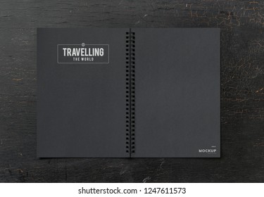 Black notebook mockup on a black table