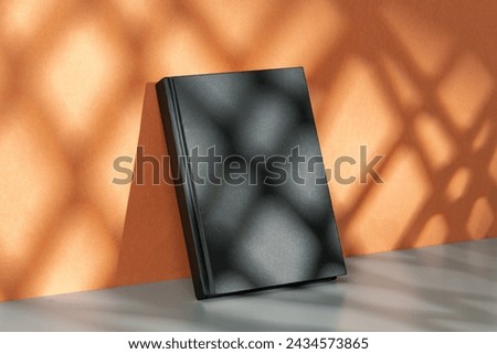 Black notepad mock up against terracotta wall