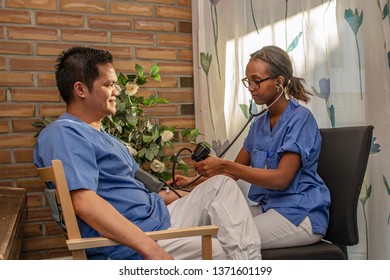 Black Nurse Taking Asian Students Multicultural,blood Pressure,diversity People,nurse And Patient,health Care,asian Man,black Woman,smile,two,man,woman,sitting,young,female,male