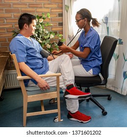 Black Nurse Taking Asian Students Multicultural,blood Pressure,diversity People,nurse And Patient,health Care,asian Man,black Woman,smile,two,man,woman,sitting,young,female,male