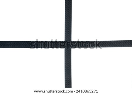 Black nylon cord strap for industrial use isolated on white background, close up plastic poly strap for cargo box. Composite cord strapping belt for securing a transportation.