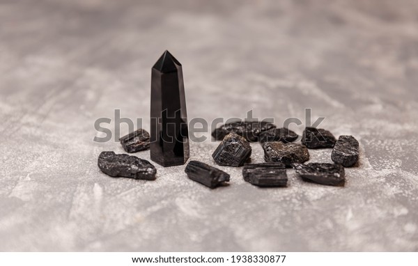 Black obsidian\
crystal wand. Natural rock specimen - raw crystal of black obsidian\
gemstone. Many pieces of crystal of natural stone black tourmaline.\
Shorl. Balancing the\
soul.