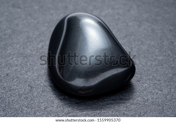 Black obsidian on a dark\
background