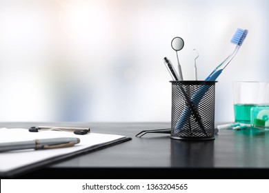 Black Office Desk Of A Dentist With Office And Dental Supplies. Front View. Horizontal Composition.