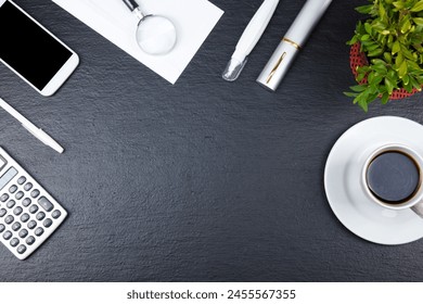 Black Office desk table with computer, pen and a cup of coffee, lot of things. Top view with copy space