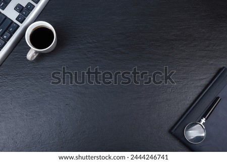 Black Office desk table with computer, pen and a cup of coffee, lot of things. Top view with copy space