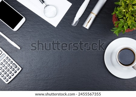 Black Office desk table with computer, pen and a cup of coffee, lot of things. Top view with copy space
