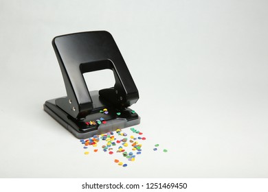 Black Office Hole Punch With Confetti On White Background