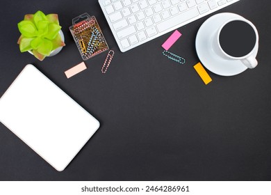 black office table with computer, pen and a cup of coffee, lot of things. Top view with copy space
