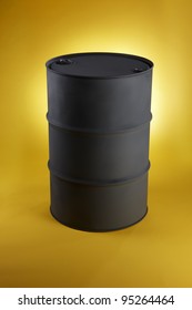 Black Oil Drum Shot On Bright Yellow Background With Space For Copy