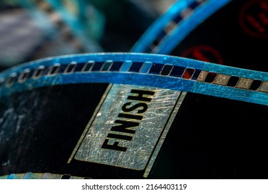 Black Old Analog Film. Selective Focus On Film Perforation And Lettering Finish. Retro Color Motion Picture Film. Industry Symbol For Shooting Process, Retro Cinematography, Photography, Memories.