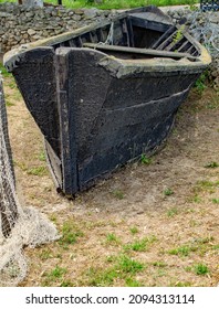 A Black Old Boat Covered In Tar