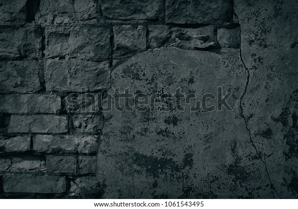 Black old brick wall with cracked fallen off\
plaster and peeling paint. Crumbled old shabby brickwork texture.\
Sinister Halloween\
background
