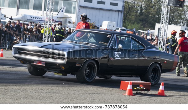 a black and old dodge charger on start line at a\
motor show competition in italy. italy-rivanazzano terme 15 october\
2017