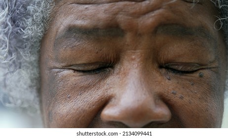 A Black Older Woman Closing Eyes In Meditation Macro Eyes Closeup