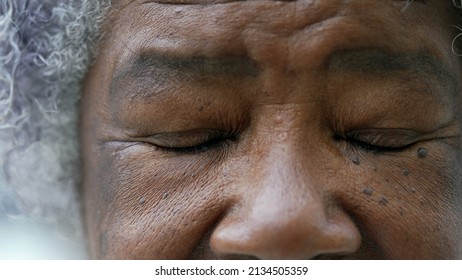 A Black Older Woman Closing Eyes In Meditation Macro Eyes Closeup