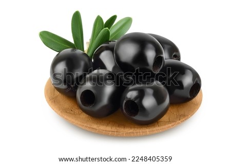 Black olives with leaves in wooden bowl isolated on a white background with full depth of field.