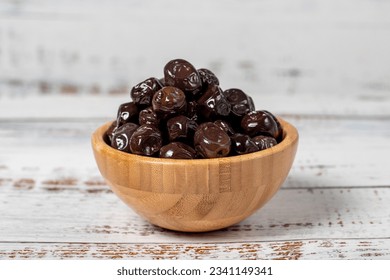 Black olives at wooden bowl. Olives on a white wood background. Mediterranean food. vegan food - Powered by Shutterstock