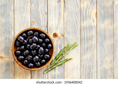 Black Olives In Wooden Bowl. Overhead View